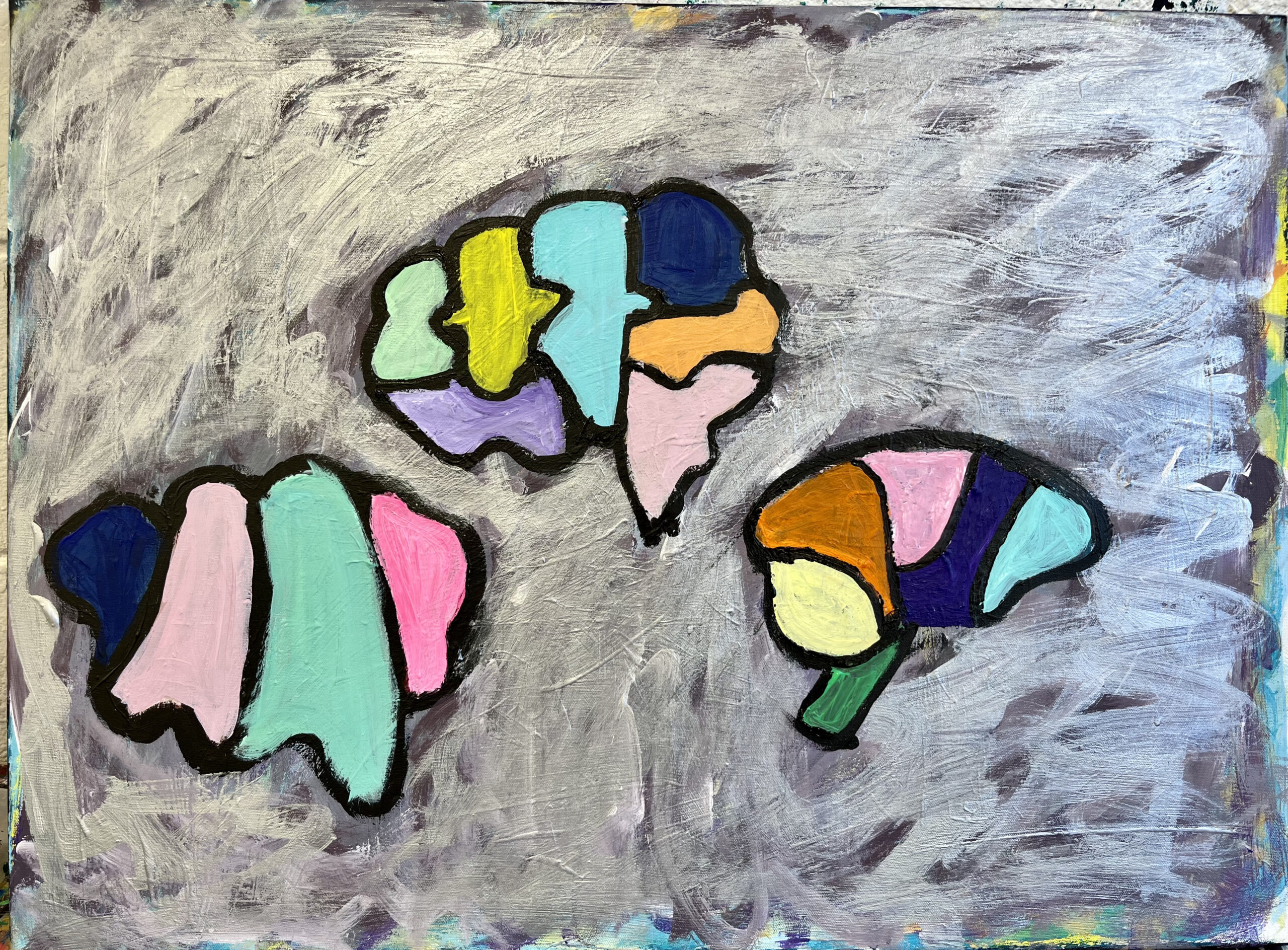 A rectangular canvas with a silver roughly painted background surrounding 3 differently drawn brain symbols in a triangular shape. Each brain is made up of different sections of colour from dark blue, pink, green, yellow peppermint, lilac and orange. These are boldly painted in acrylic paint. There brains look like jigsaw pieces put together.