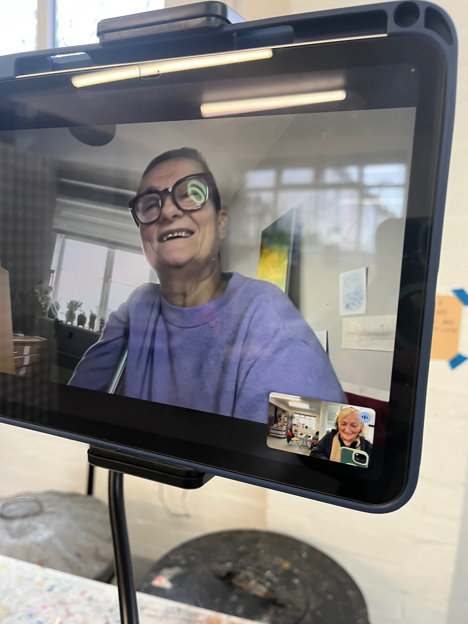 A photo of Sarah talking on a Zoom call with Syncing Space guest artist, Tanya Raabe they are laughing together