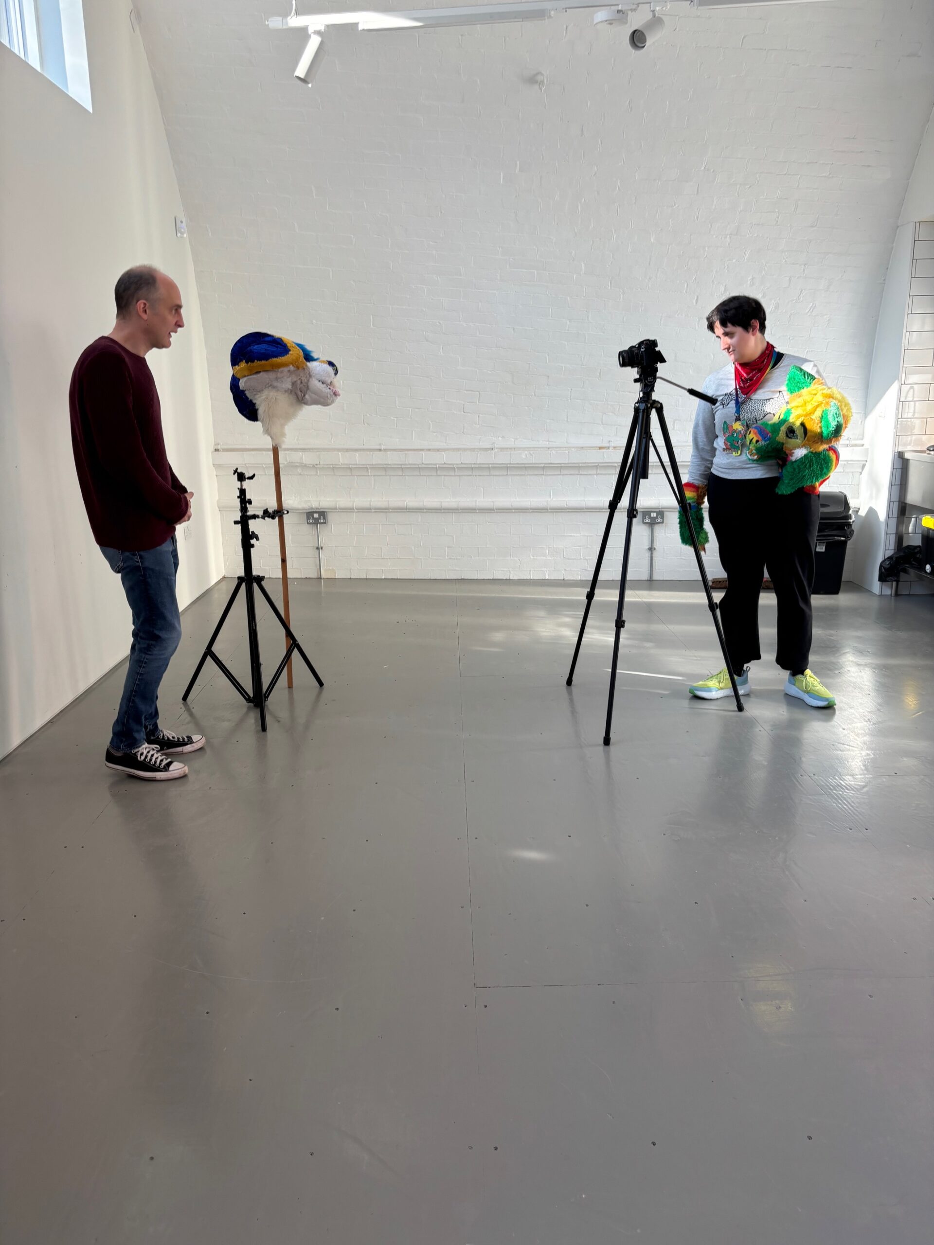 Lucy and Dave stand with the animal props and cameras for filming