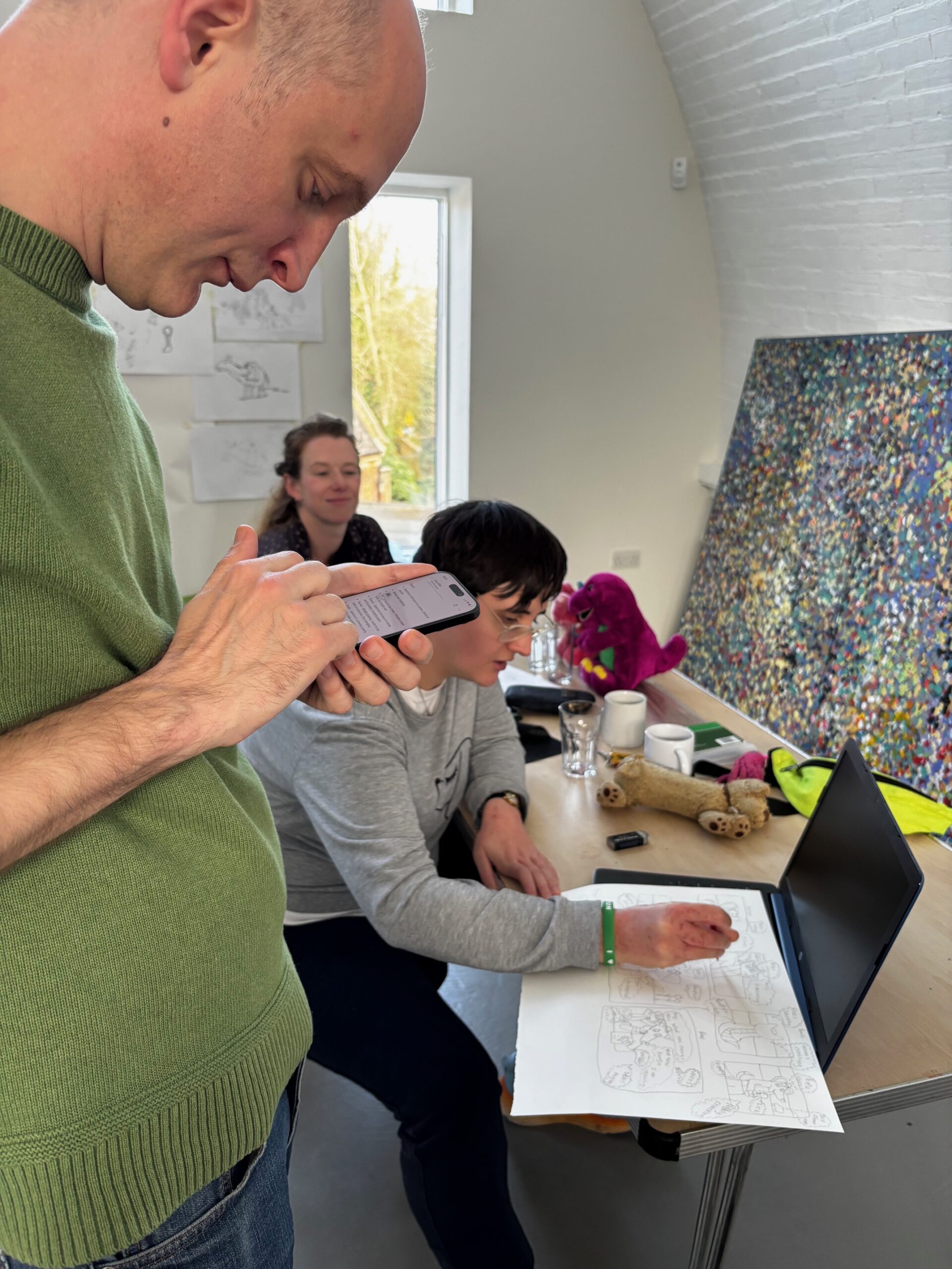 Lucy in the PAW studio doing a storyboard alongside Dave Packer who writes down her ideas