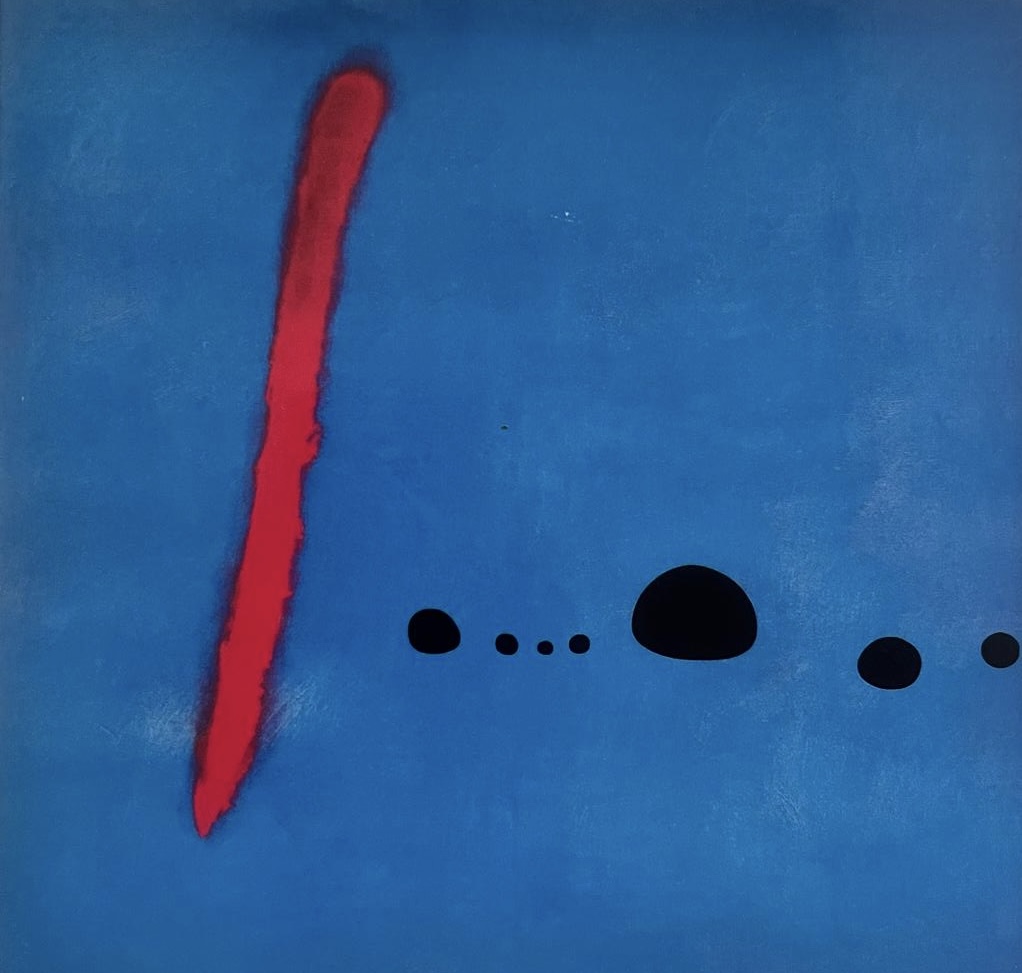A painting of mid blue background with a thick red slightly diagonal vertical line on the left hand side. With a series of different sizes black pebble shapes on a horizontal line starting after the red mark one third up the page.