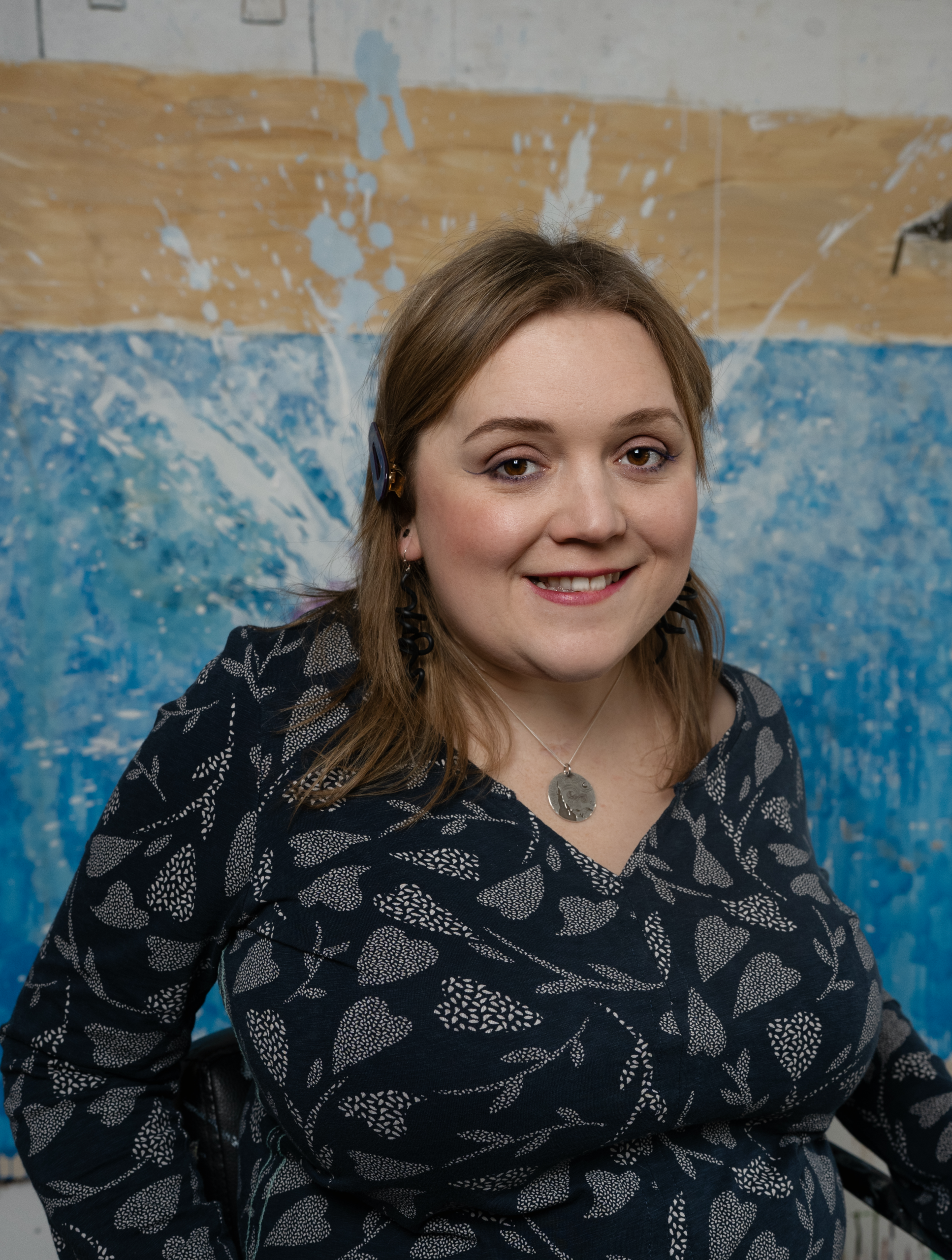 This is a portrait of me in front of my work Grace and Johnny's Biggest Splash from 2025