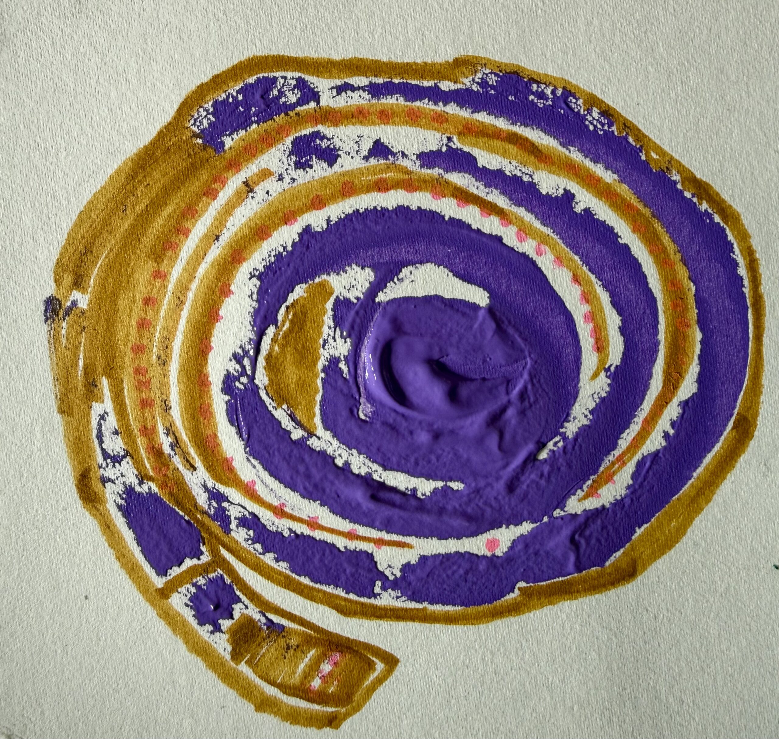 A purple spiral with pink dots and yellow lines around the outside of the spiral to make it stand out