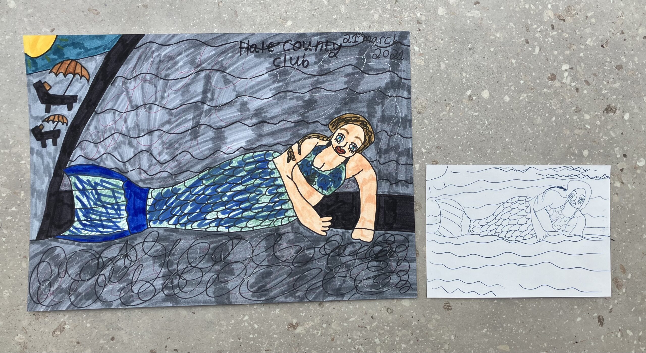 My two drawings, next to each other. The big one in felt tip and pen is on the left and the small carbon drawing on the right.