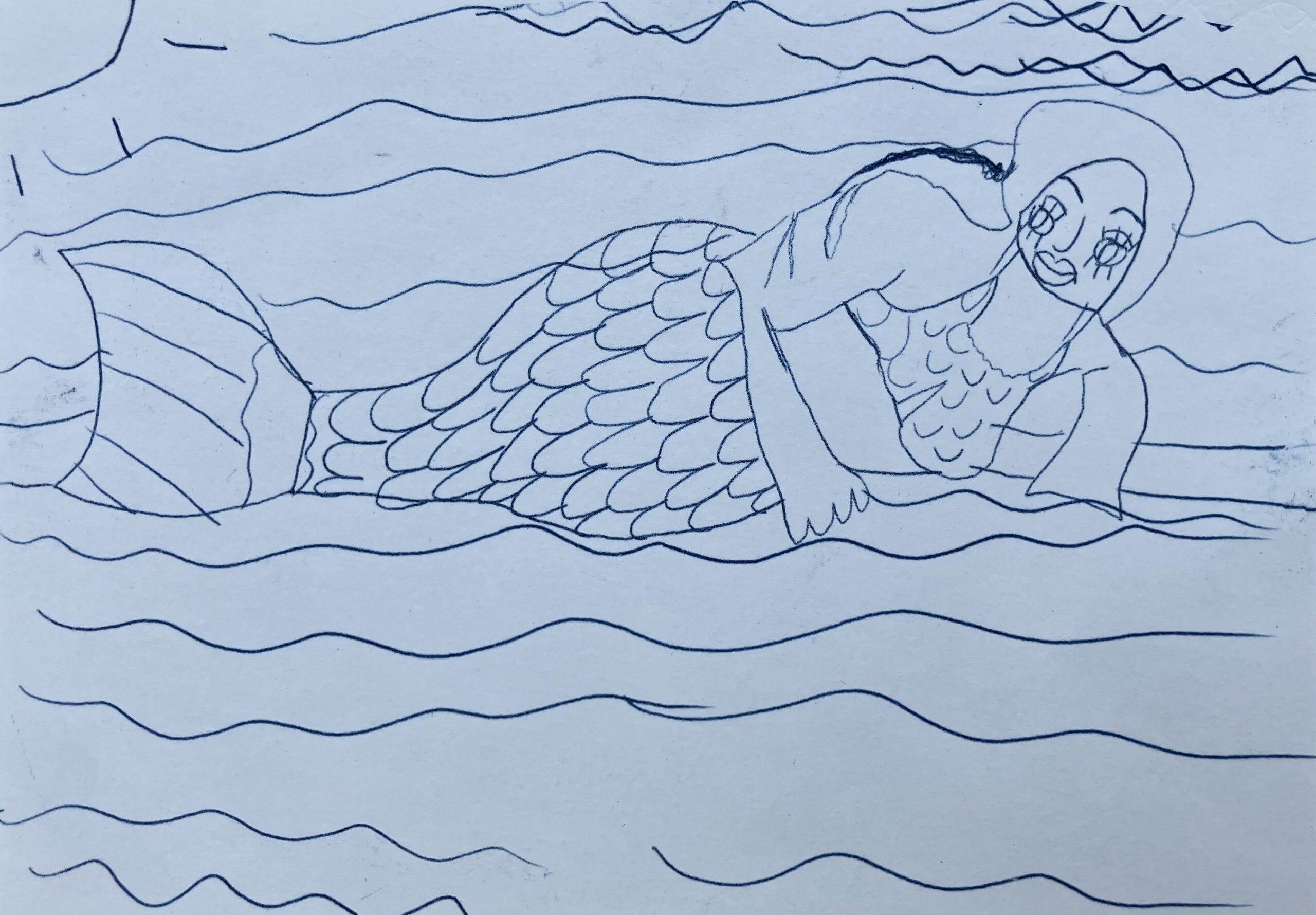 This is a drawing I made using blue carbon paper. It is a blue drawing on a white piece of paper. It is a drawing of me wearing my mermaid costume at the swimming pool.