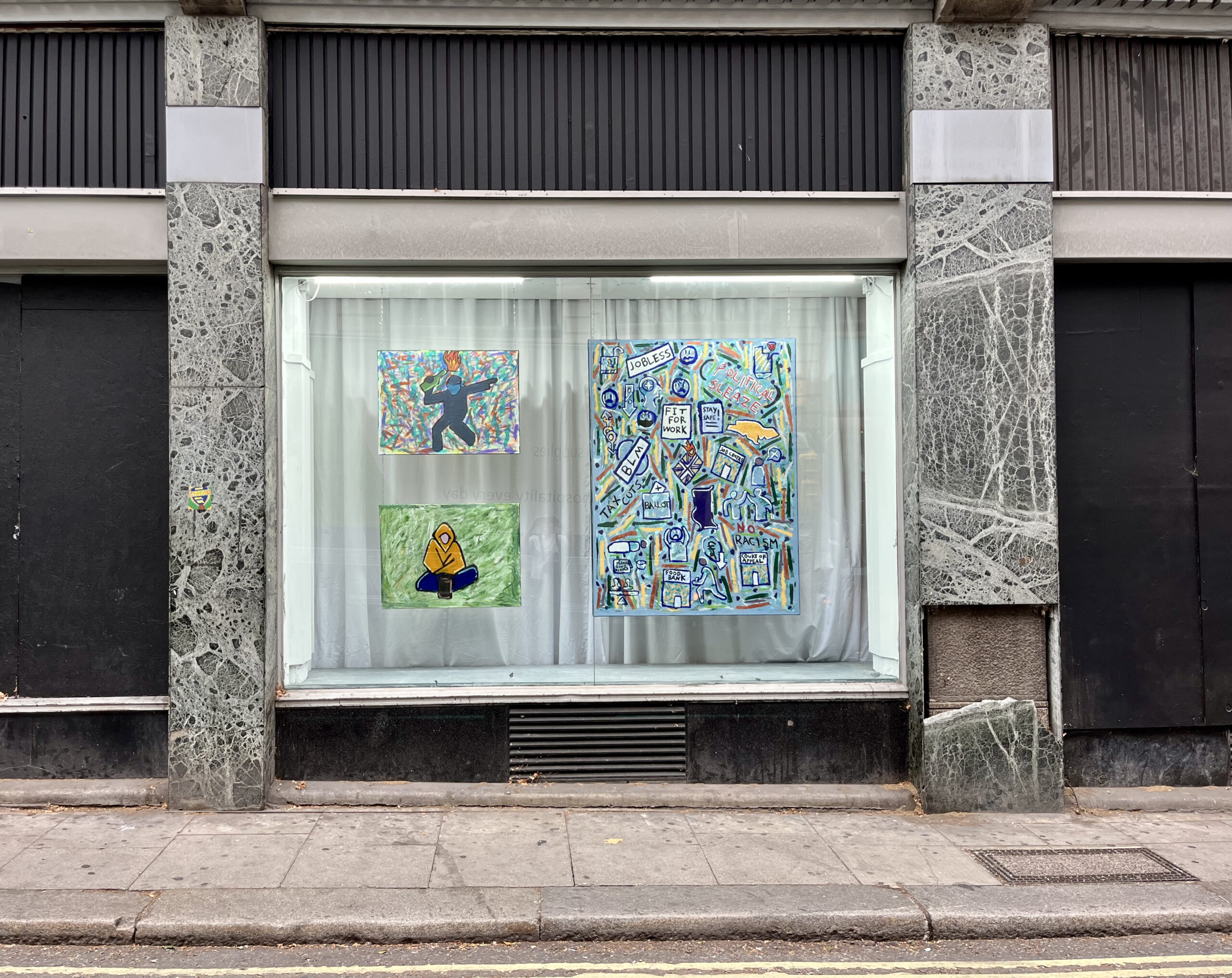 Photo of exhibition window showing three acrylic paintings called 'Civil feud', 'Destitute Britain' and Political Sleaze'