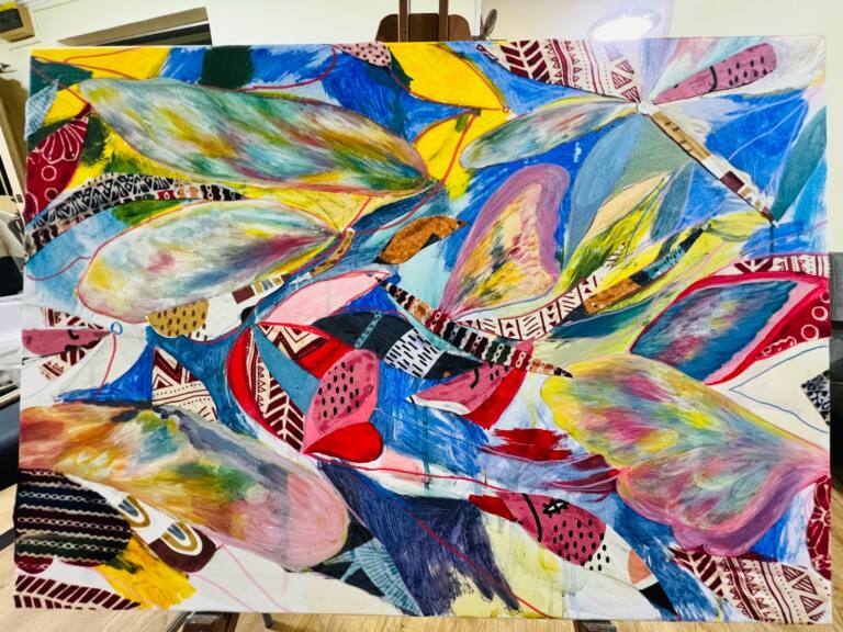 Colourful abstract mixed media painting featuring overlapping butterfly wings and organic shapes in blue, yellow, pink and green.