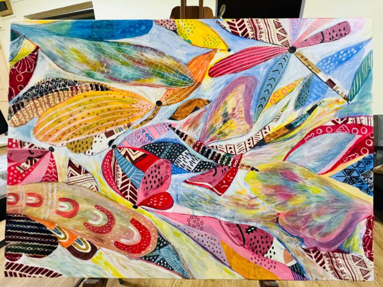 Vibrant abstract mixed media painting featuring overlapping butterfly wings in blue, yellow, pink, orange and red.