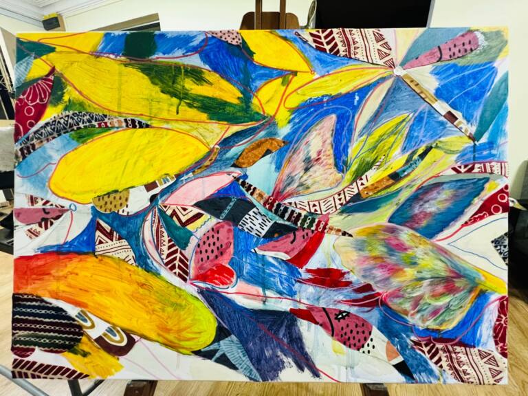 Colourful abstract mixed media painting featuring sweeping shapes in yellow, blue, pink and green with geometric patterned fabric.