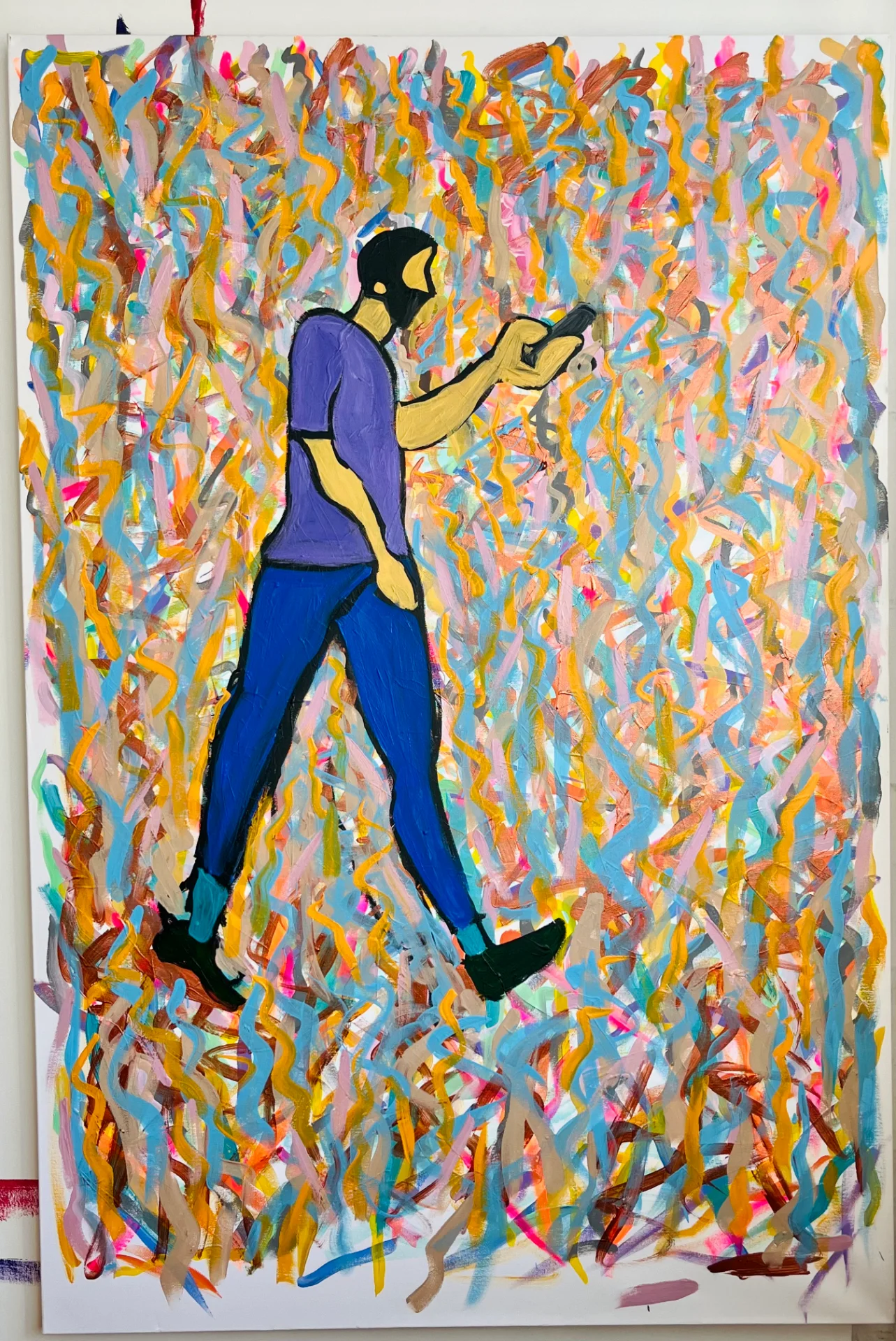 A large canvas painting with a multitude of colours in the background. These look like squiggles of various colours going in different directions on a large canvas with a figure of a man wearing a purple t shirt and dark blue trousers in a walking pose looking at his phone, not paying any attention to anything around him. I'm highlighting the fact .that our everyday lives has been taken over by technology.